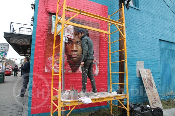 SXSW-2014, A lone artist, one of Austin Texas' thriving community of Artists and Musicians; hand paints a detailed portrait for an adverting campaign